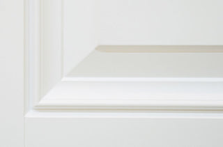 FRAMEWELL primed fiberglass entry door close-up, showcasing high-definition raised panel embossment and smooth finish.
