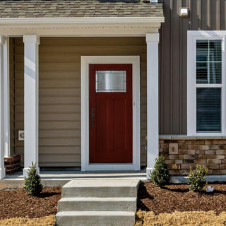 Vibrant red FRAMEWELL Craftsman-style fiberglass entry door (36x80) with a rich wood grain texture and ornate decorative glass featuring patina caming.
